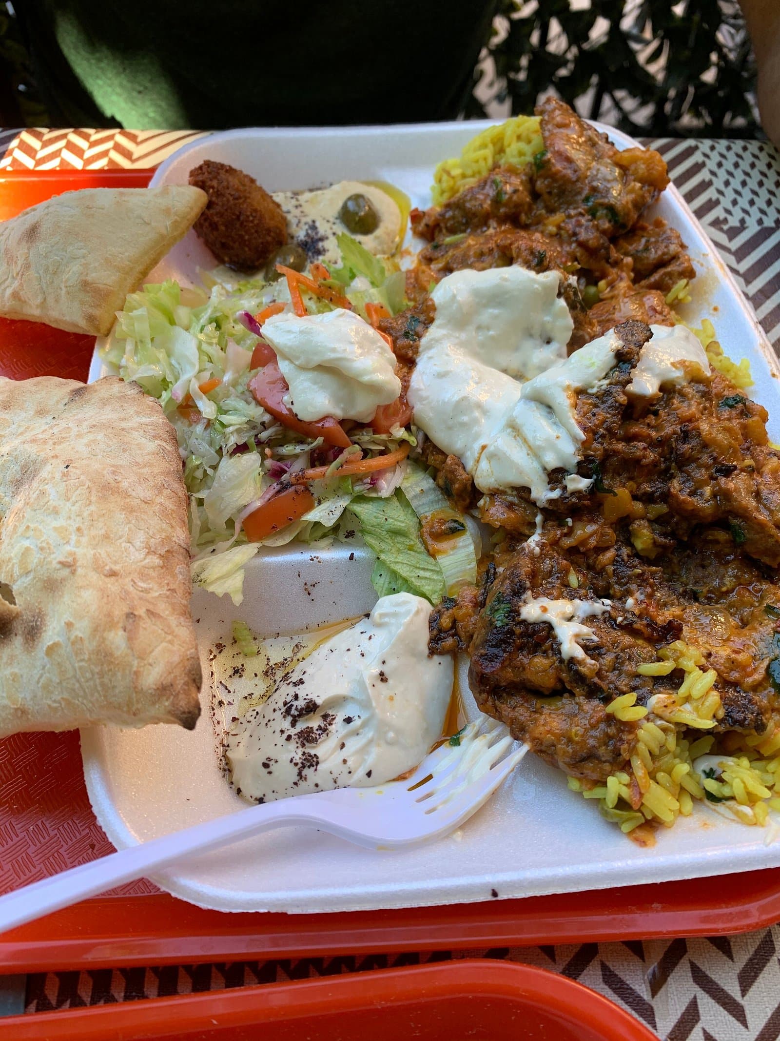 Chicken shawarma platter with house pita, salad, and tzatziki