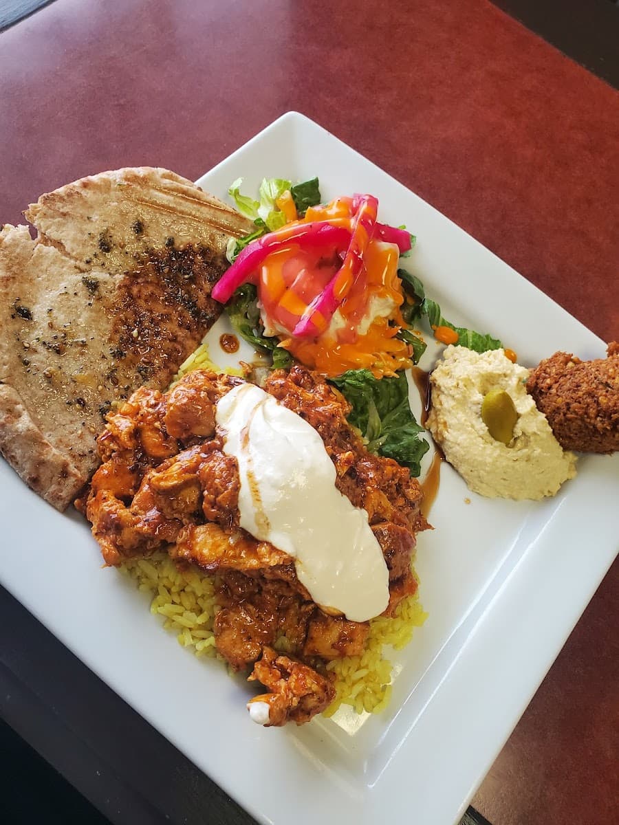 Doner platter with grilled pita, saffron rice, falafel, hummus, and fresh salad